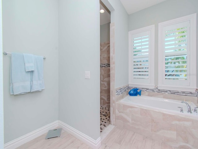 bathroom with separate shower and tub