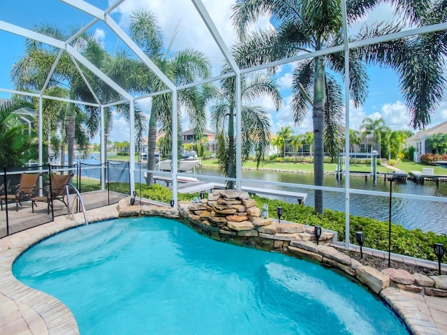 view of pool with a water view, glass enclosure, a patio area, and a dock