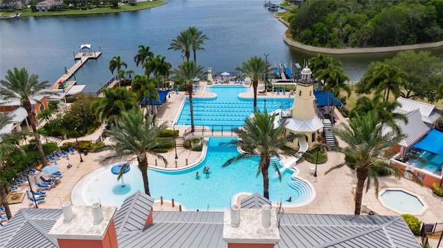 view of pool featuring a water view and a patio