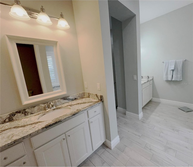 bathroom with vanity and hardwood / wood-style flooring