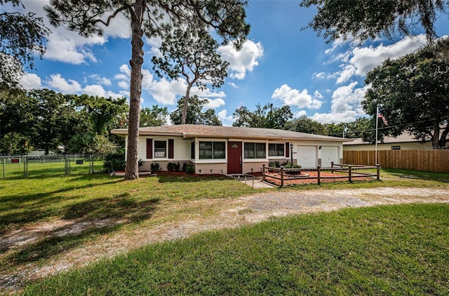 single story home featuring a front yard and a garage