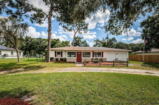 single story home with a front yard and a garage