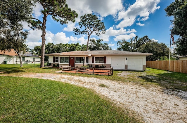 ranch-style home with a garage and a front lawn