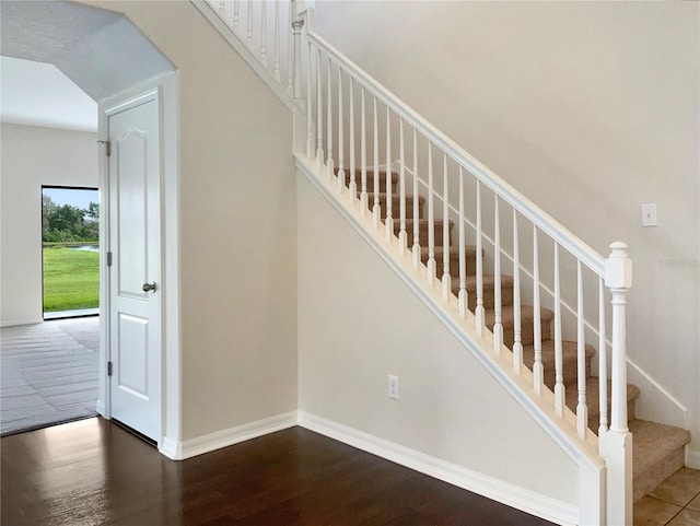 stairs featuring hardwood / wood-style flooring