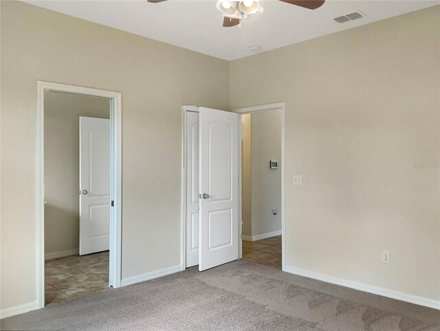 unfurnished bedroom featuring ceiling fan and light colored carpet