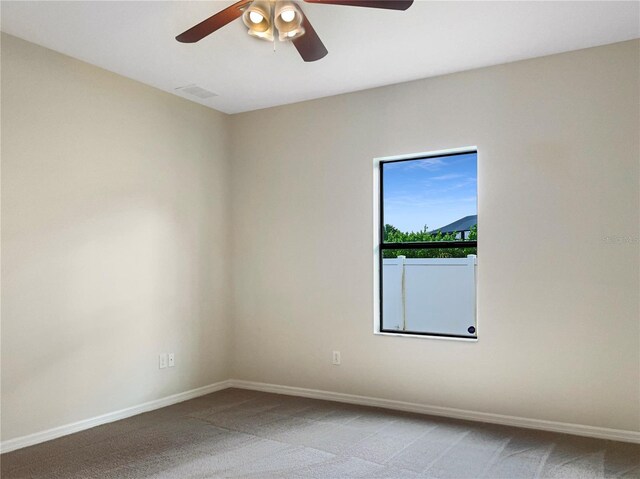 unfurnished room featuring ceiling fan and light carpet