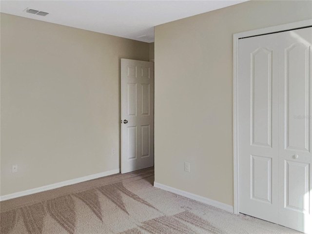 unfurnished bedroom featuring light colored carpet