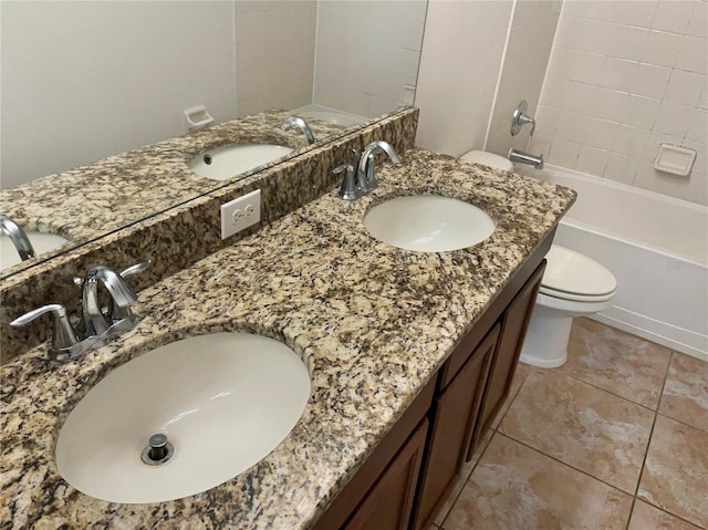 full bathroom featuring tiled shower / bath combo, tile patterned flooring, vanity, and toilet