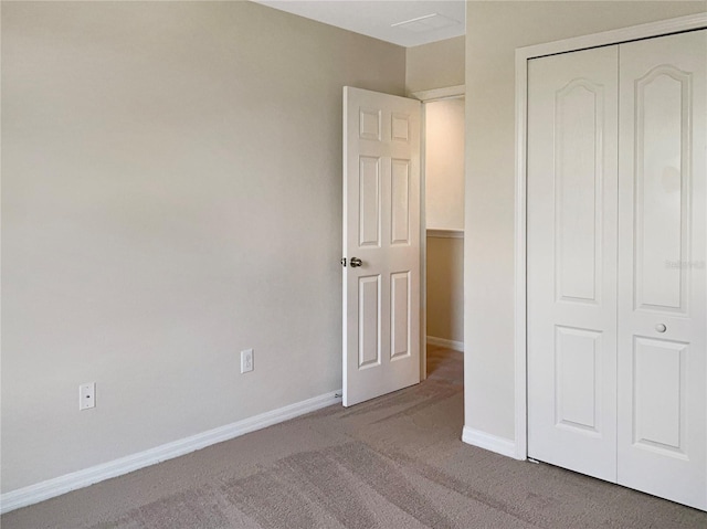 unfurnished bedroom featuring a closet and carpet floors