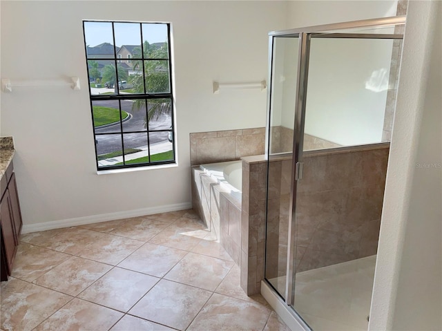 bathroom featuring vanity, separate shower and tub, and tile patterned floors