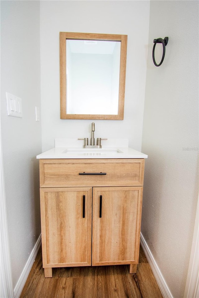 bathroom with hardwood / wood-style floors and vanity