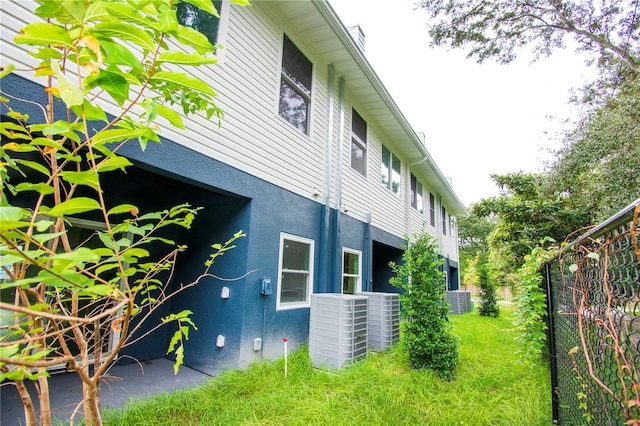 view of side of property with central AC unit