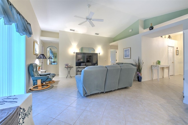 tiled living room featuring ceiling fan and lofted ceiling