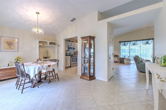 tiled dining space featuring ceiling fan with notable chandelier and lofted ceiling