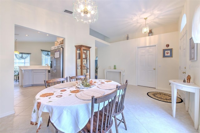 dining room featuring an inviting chandelier and light tile patterned floors