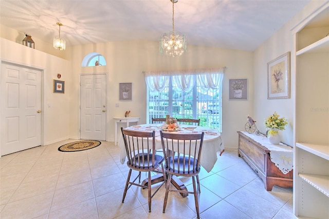 tiled dining area featuring a chandelier