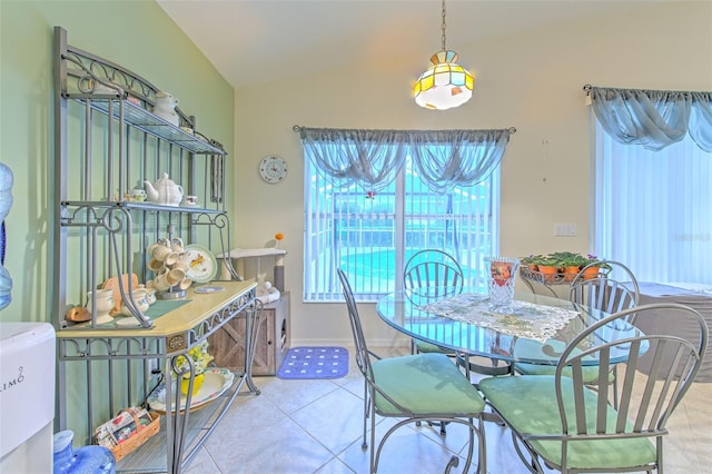 tiled dining room with vaulted ceiling