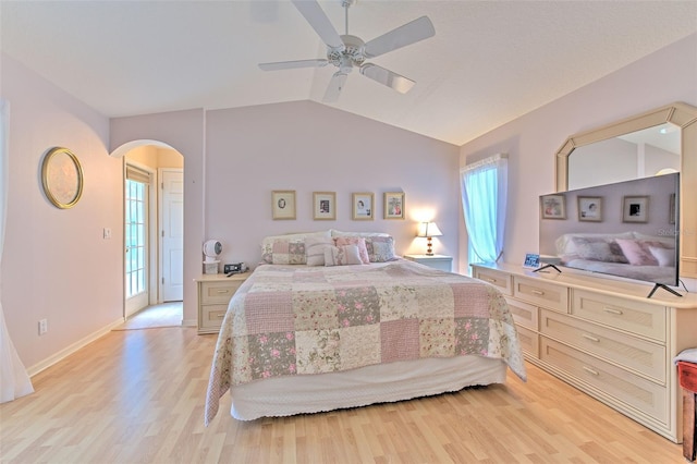 bedroom featuring ceiling fan, light hardwood / wood-style flooring, vaulted ceiling, and multiple windows