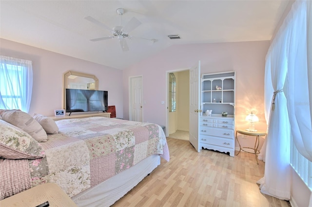 bedroom with vaulted ceiling, light hardwood / wood-style floors, and ceiling fan