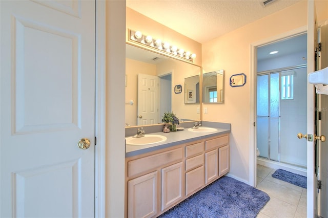 bathroom featuring vanity, walk in shower, a textured ceiling, tile patterned flooring, and toilet