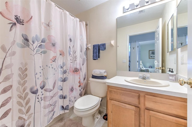 bathroom featuring vanity, toilet, a textured ceiling, and curtained shower