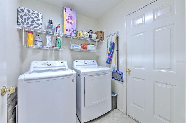 washroom featuring light tile patterned floors and separate washer and dryer