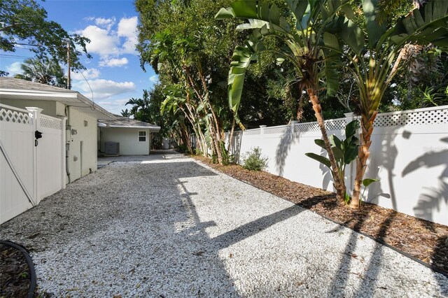 view of yard with central AC and a patio