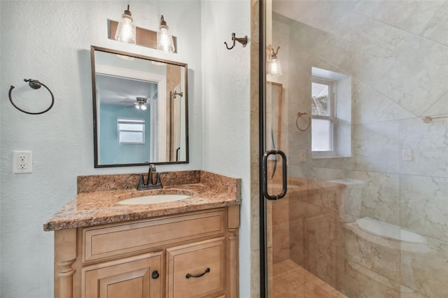 bathroom with vanity and a shower with door