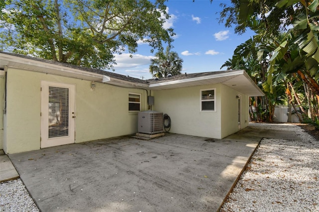 rear view of property with a patio and central AC