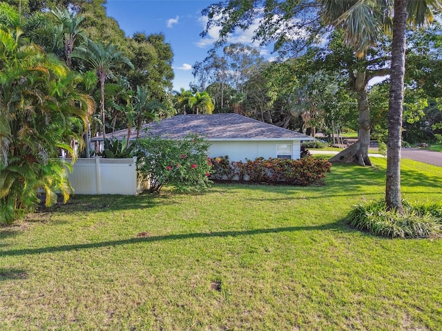 view of property exterior with a lawn