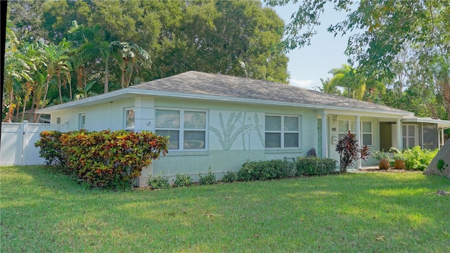 ranch-style home featuring a front yard