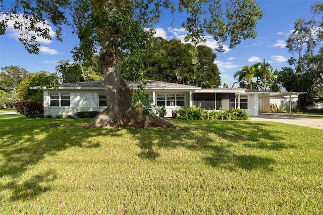 ranch-style home featuring a carport and a front yard