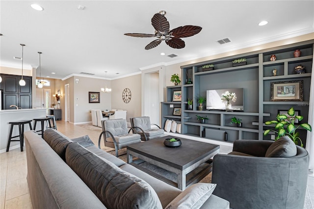 living room with ceiling fan with notable chandelier, built in features, and crown molding