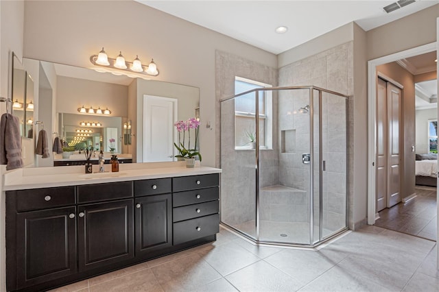 bathroom with tile patterned flooring, vanity, an enclosed shower, and crown molding