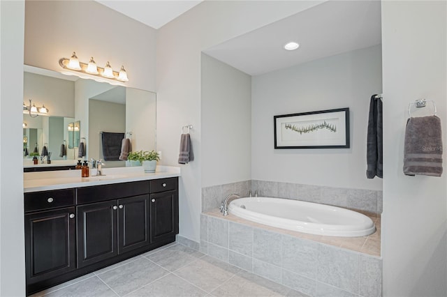 bathroom with vanity, a relaxing tiled tub, and tile patterned floors