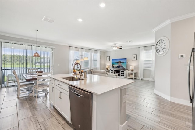 kitchen featuring an island with sink, white cabinets, dishwasher, decorative light fixtures, and sink