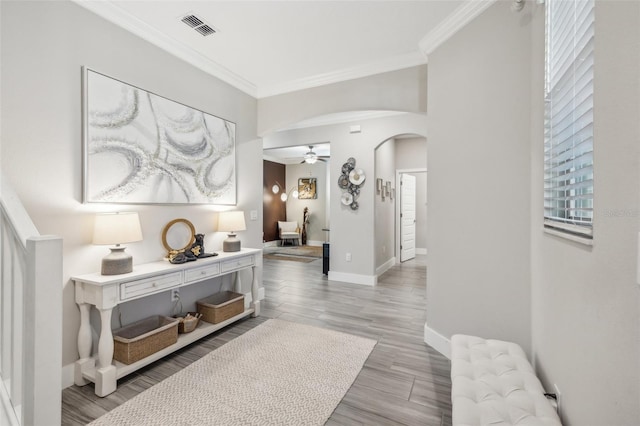 hallway with light hardwood / wood-style flooring and ornamental molding