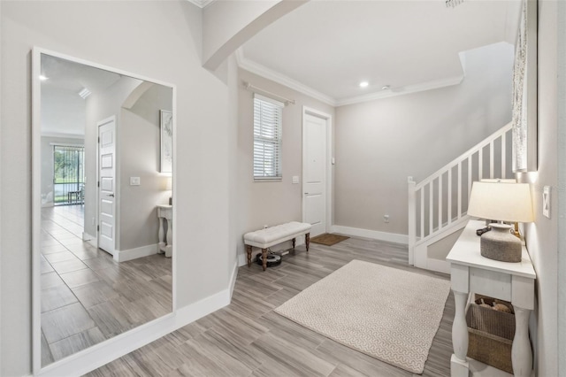 entryway featuring light hardwood / wood-style flooring and ornamental molding