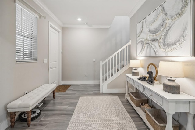 foyer featuring ornamental molding and hardwood / wood-style floors