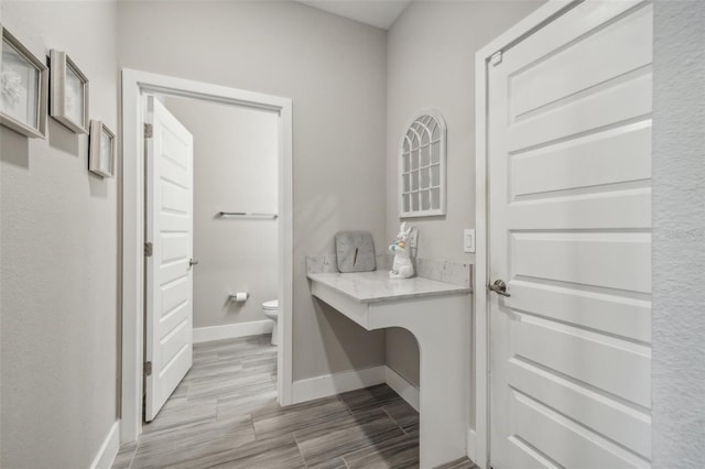 bathroom with hardwood / wood-style floors and toilet