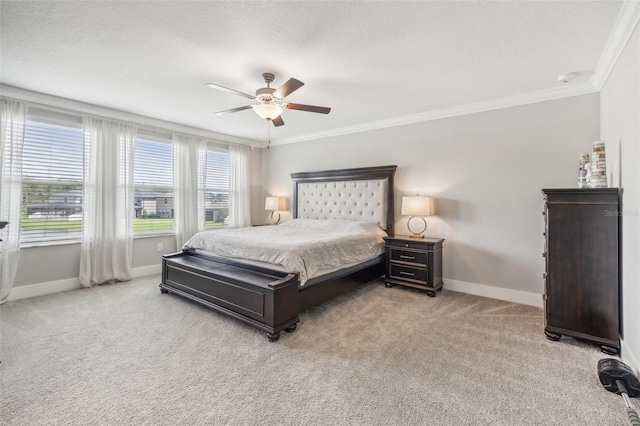 carpeted bedroom featuring a textured ceiling, ornamental molding, and ceiling fan