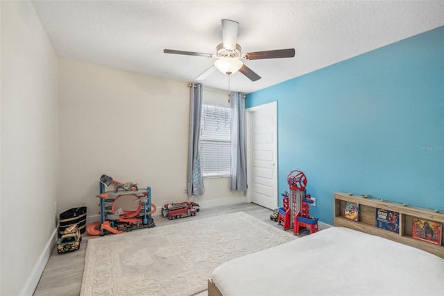 bedroom with light wood-type flooring and ceiling fan