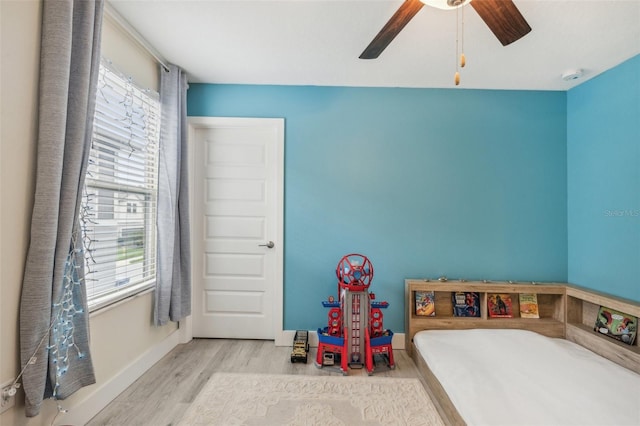 recreation room with ceiling fan, light hardwood / wood-style flooring, and a wealth of natural light