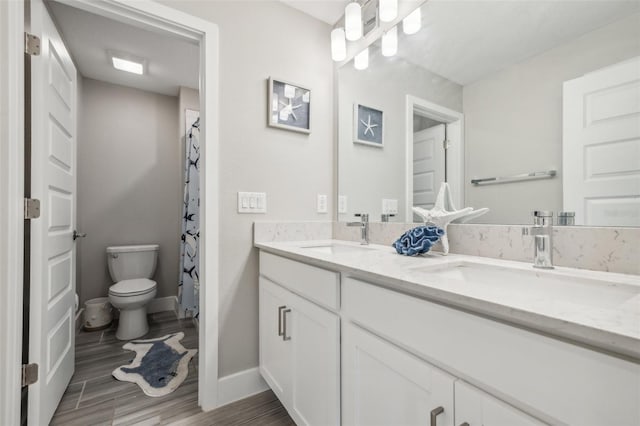 bathroom featuring a shower with curtain, vanity, hardwood / wood-style floors, and toilet