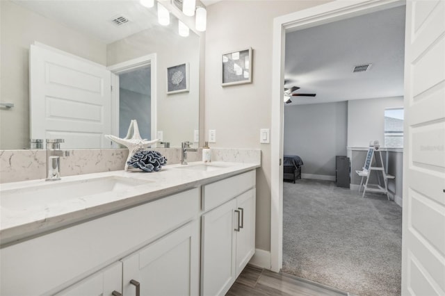 bathroom featuring ceiling fan, hardwood / wood-style flooring, and vanity