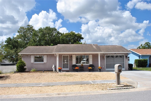 ranch-style house with covered porch and a garage