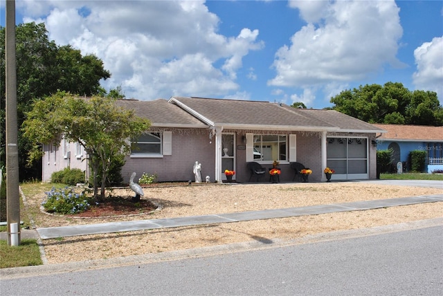 ranch-style home featuring a garage and covered porch