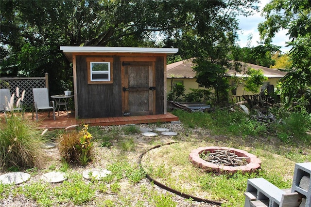 view of outdoor structure featuring an outdoor fire pit