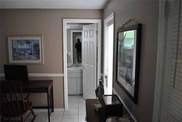 interior space with a textured ceiling and sink