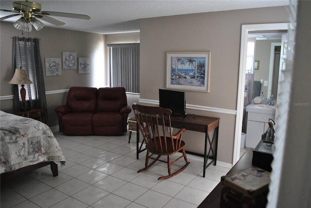 tiled bedroom with sink and ceiling fan